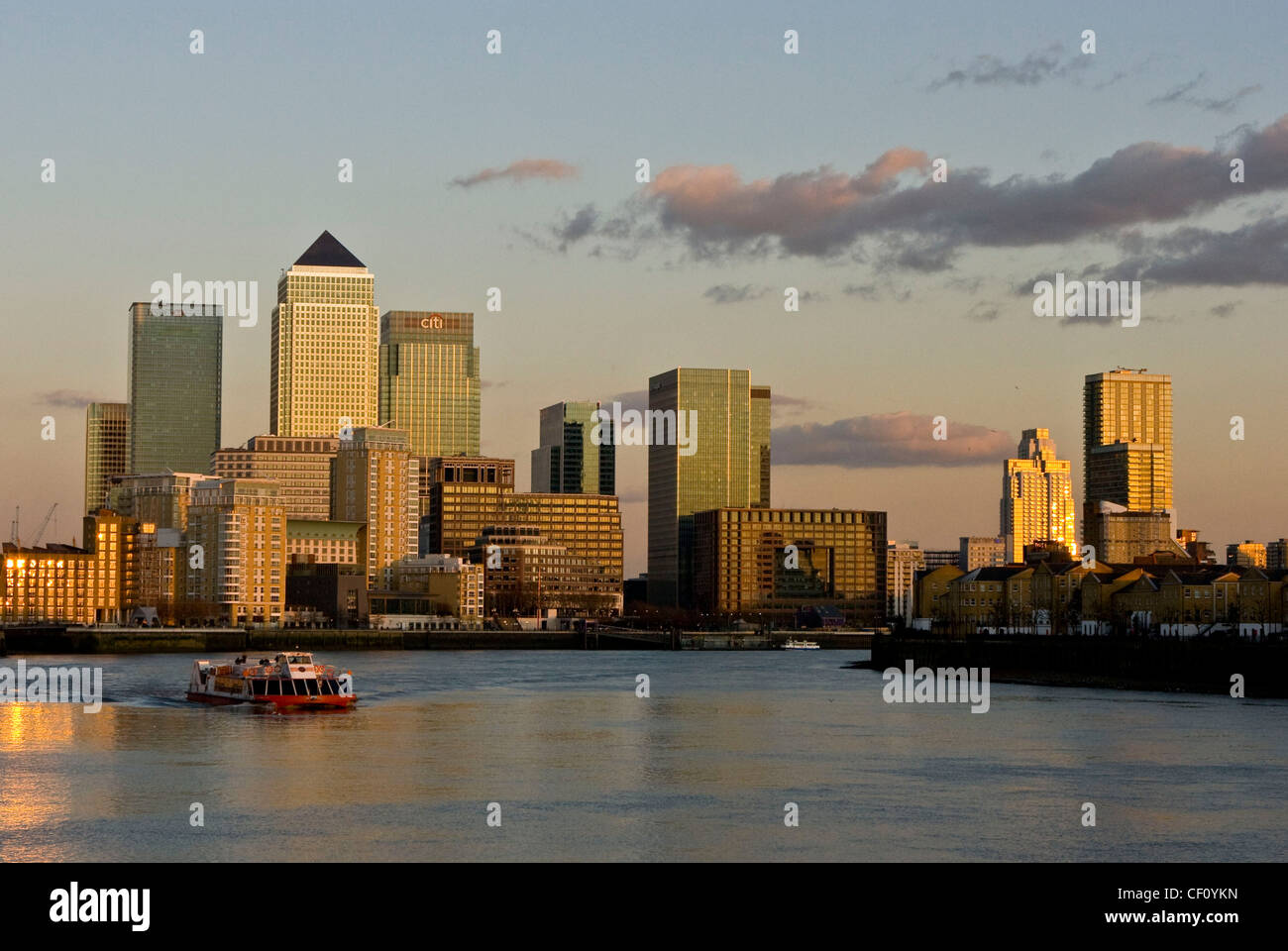 Canary Wharf skyline and riverboat transport on river Thames at ...