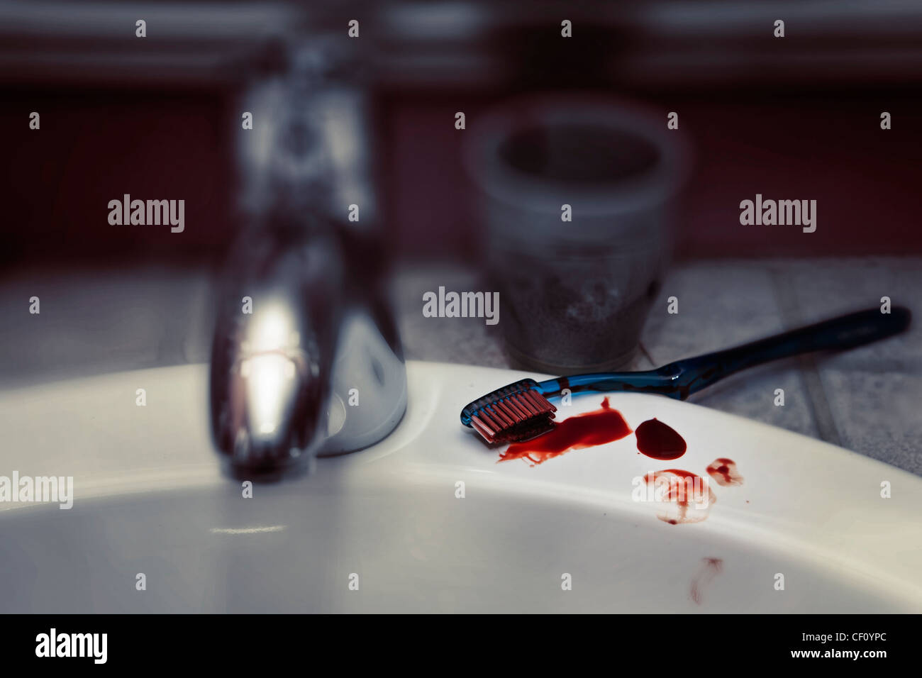Sink with faucet and bloody toothbrush Stock Photo