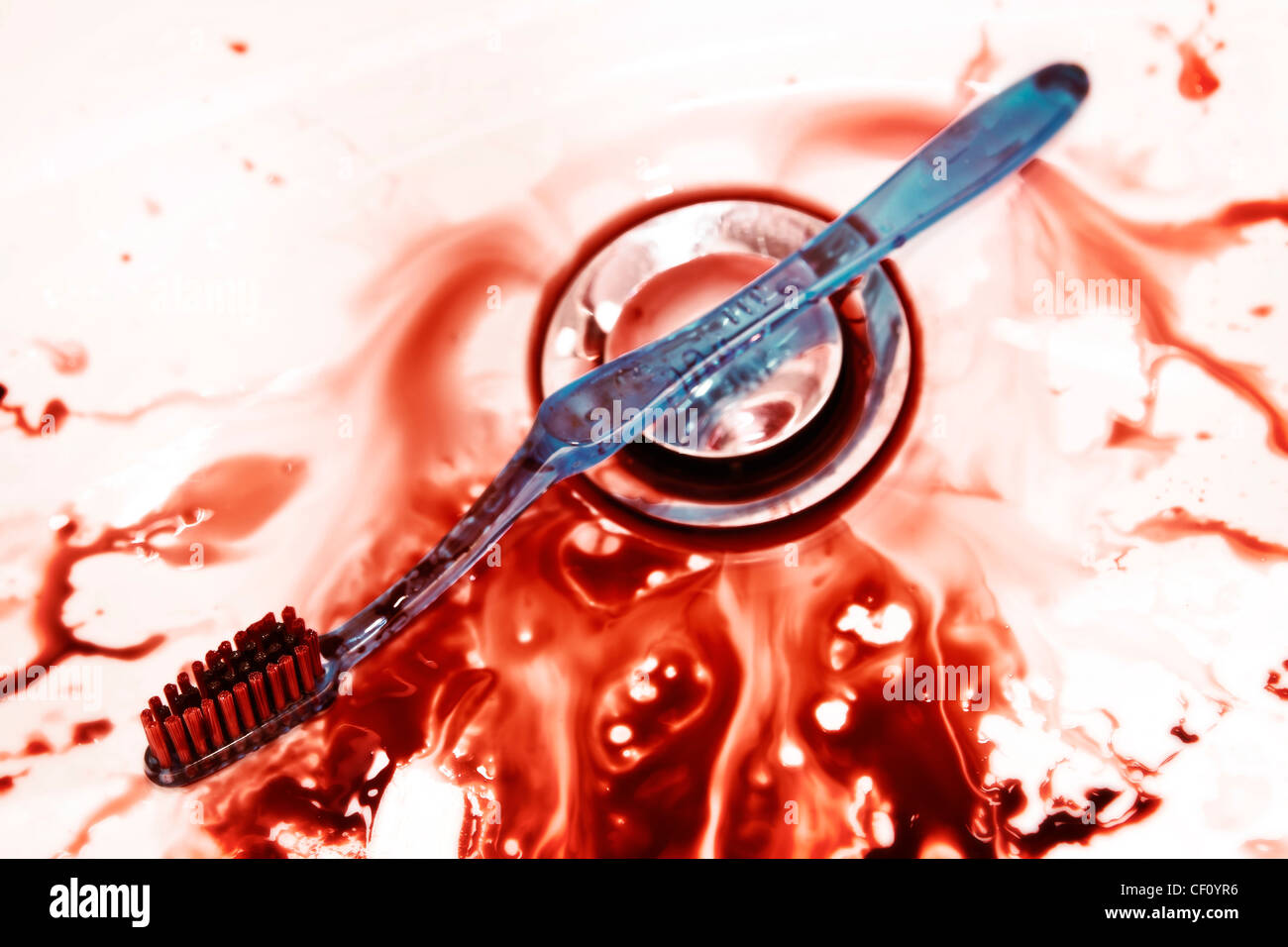 Sink with faucet and bloody toothbrush Stock Photo