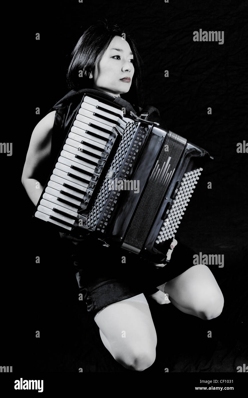 young woman playing accordion Stock Photo