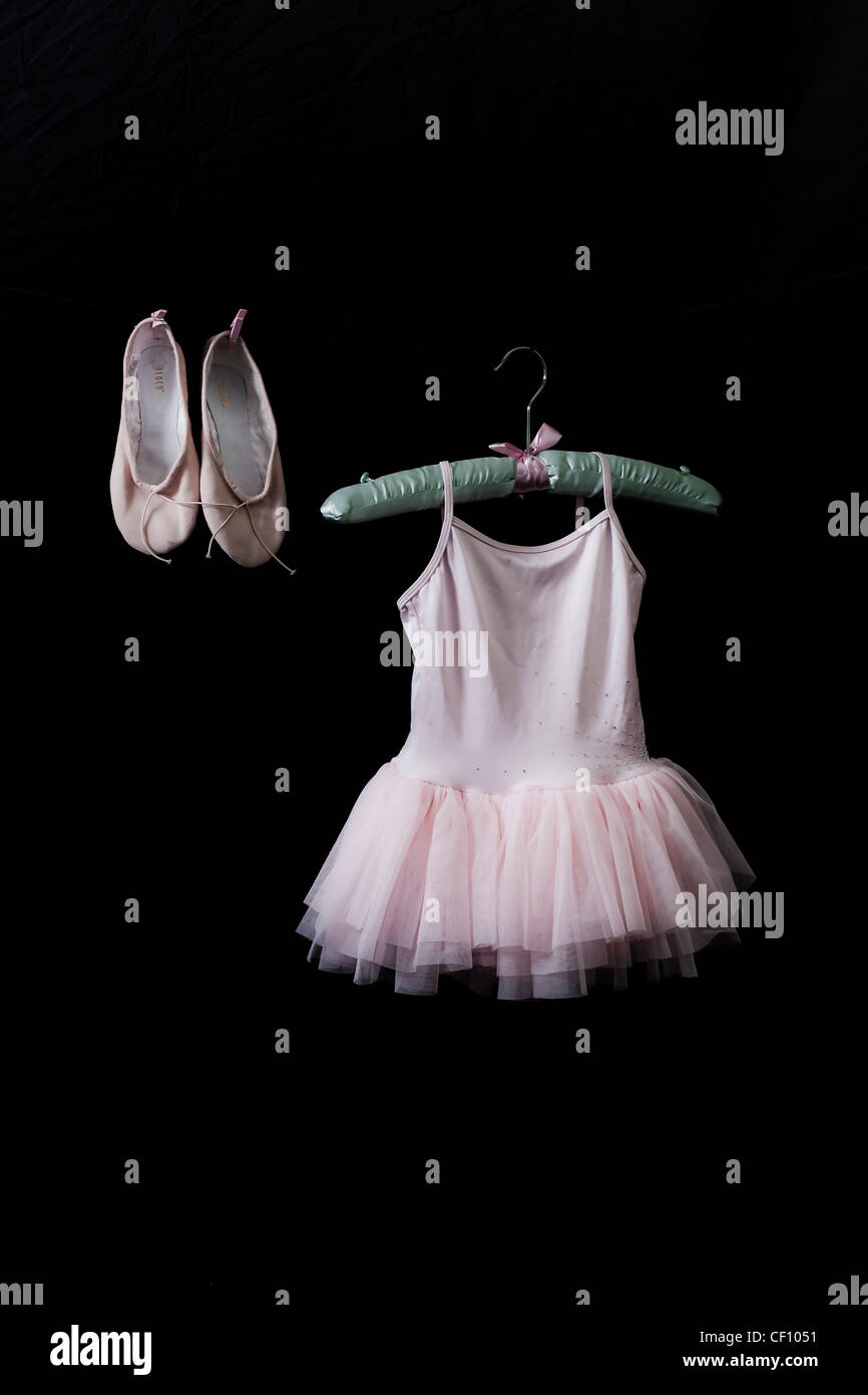 Ballet dress on a satin hanger with ballet shoes Stock Photo