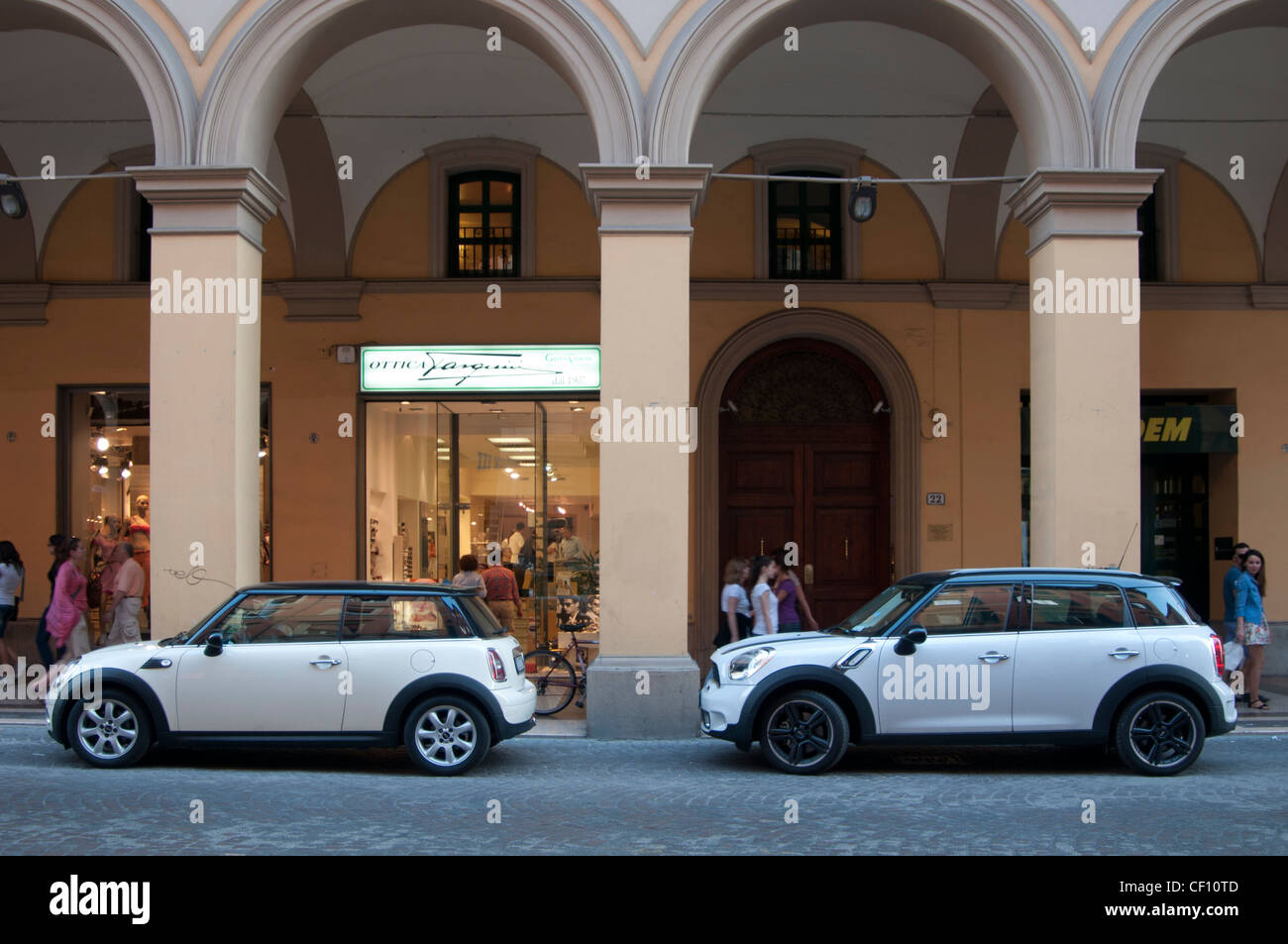Two Mini automobiles in mainstreet Bologna, Italy Stock Photo