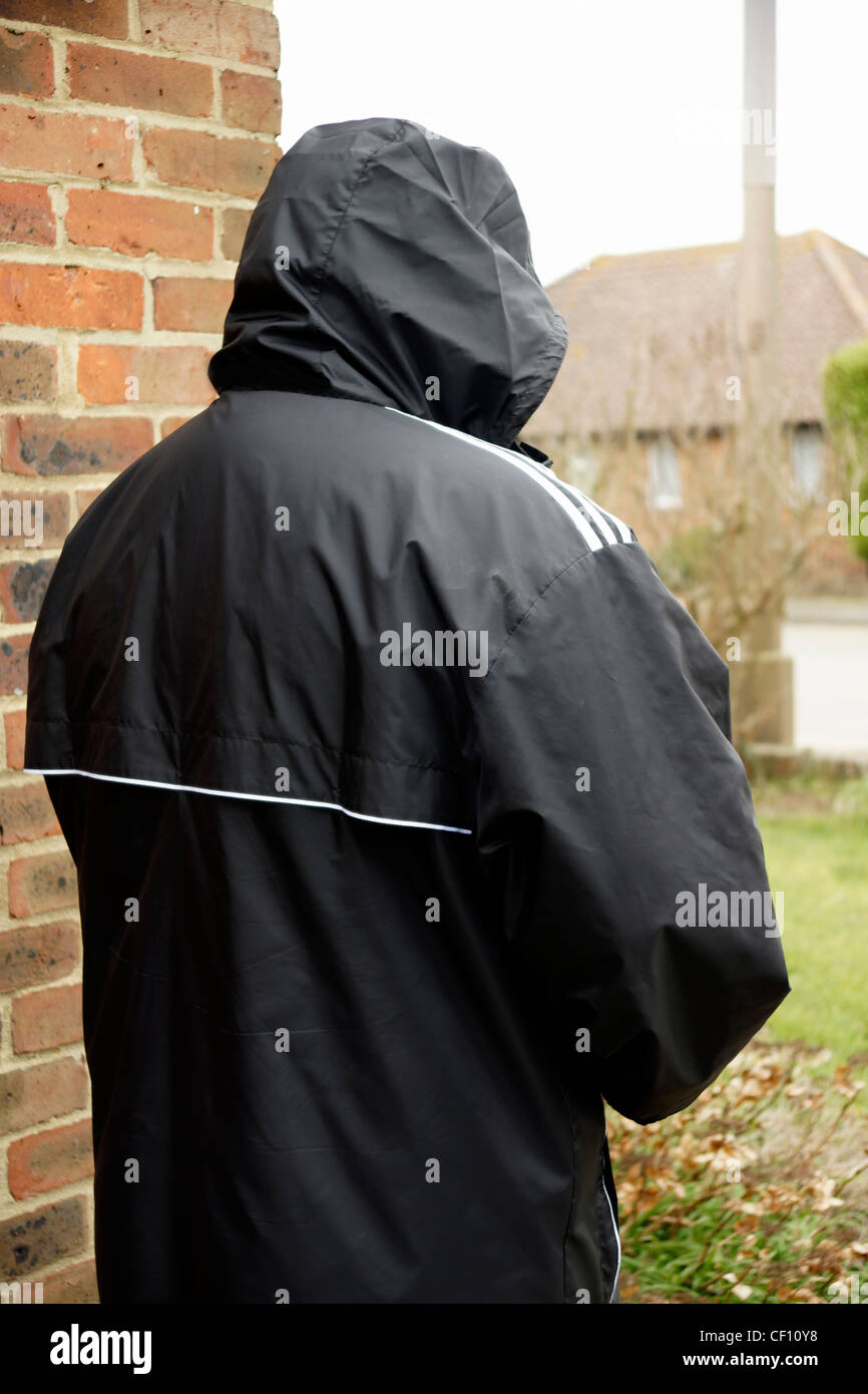 Undesirable character rogue hoodie acting suspiciously MODEL RELEASED Stock Photo