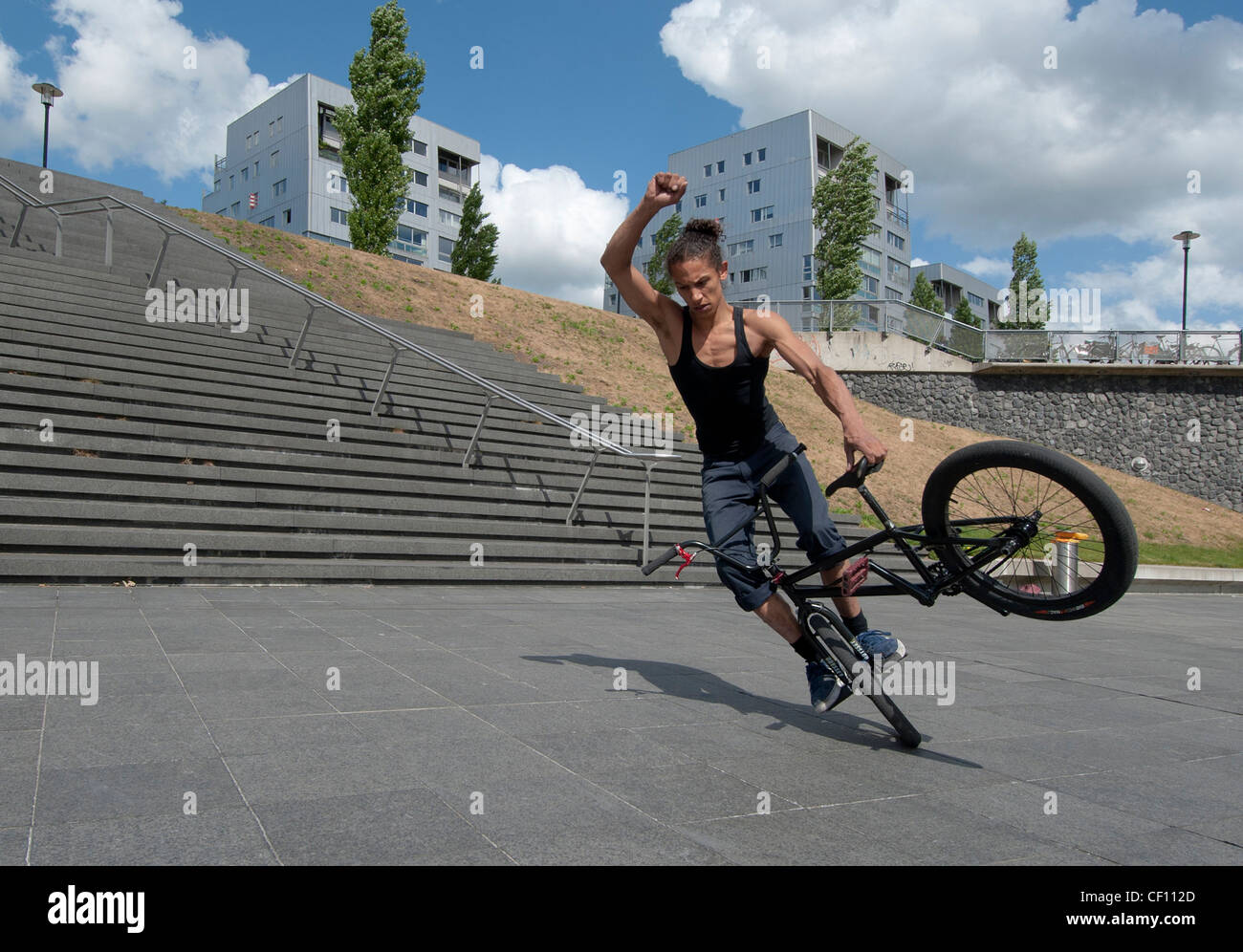 stunt biker practicing on his bike Stock Photo