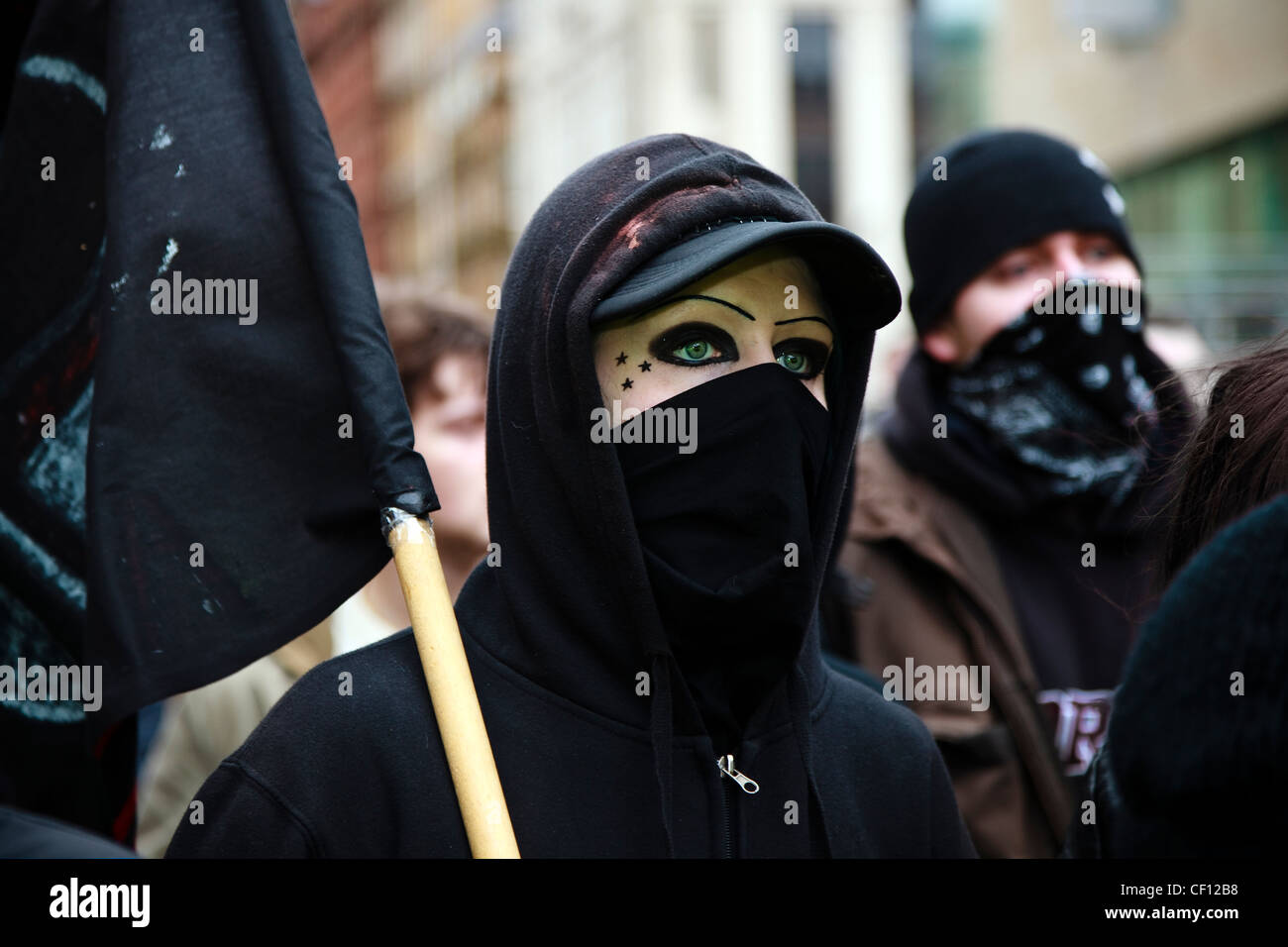 Demonstrator with a black flag and face covered up, at a street demonstration Glasgow, against racism,Scotland, UK Stock Photo