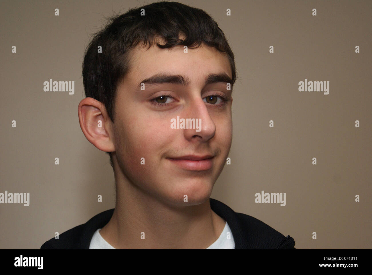 Sly Smile on teenage boy's face Stock Photo Alamy