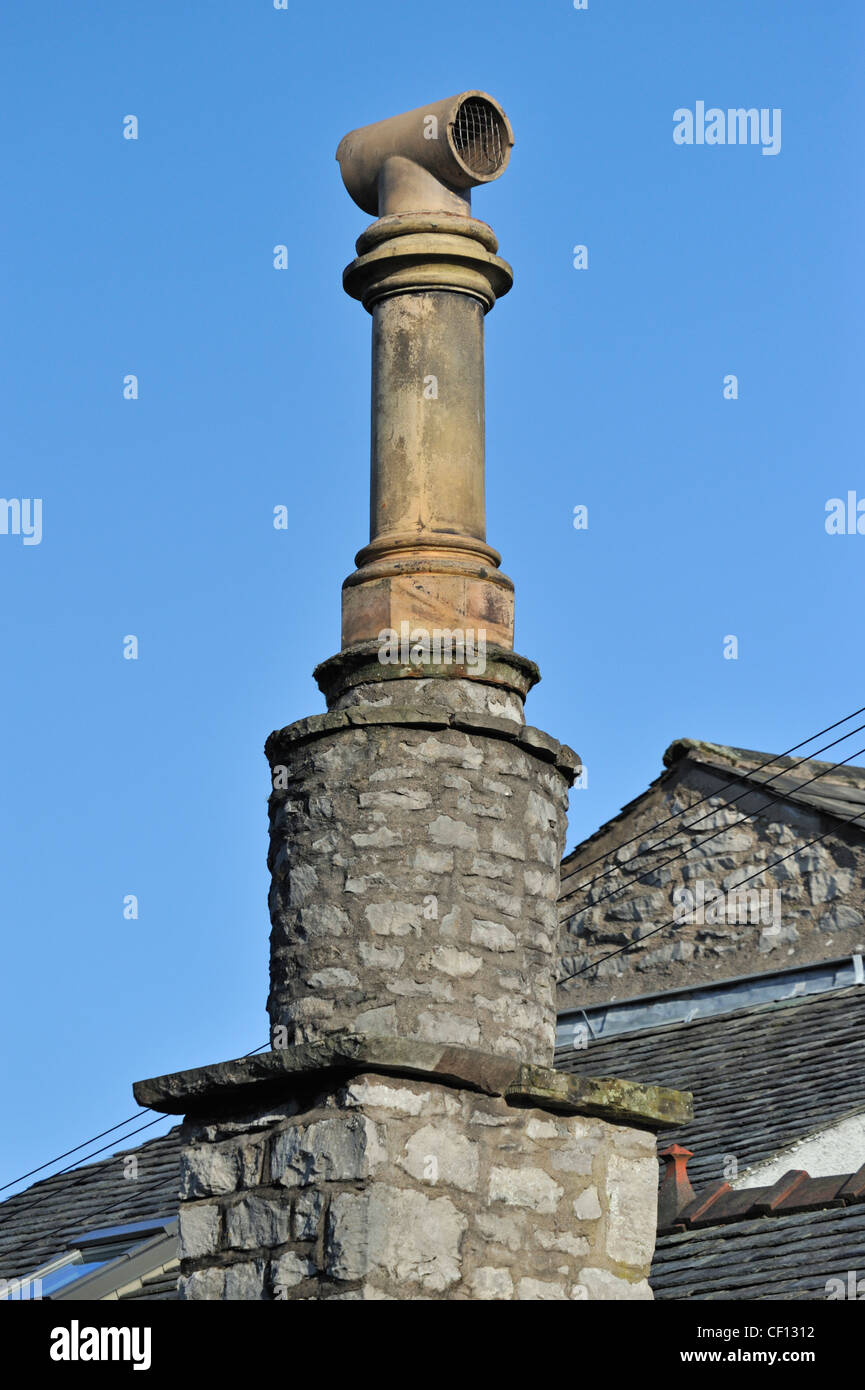 Cylindrical stone chimney stack with one pot. Castle Street, Kendal, Cumbria, England, United Kingdom, Europe. Stock Photo