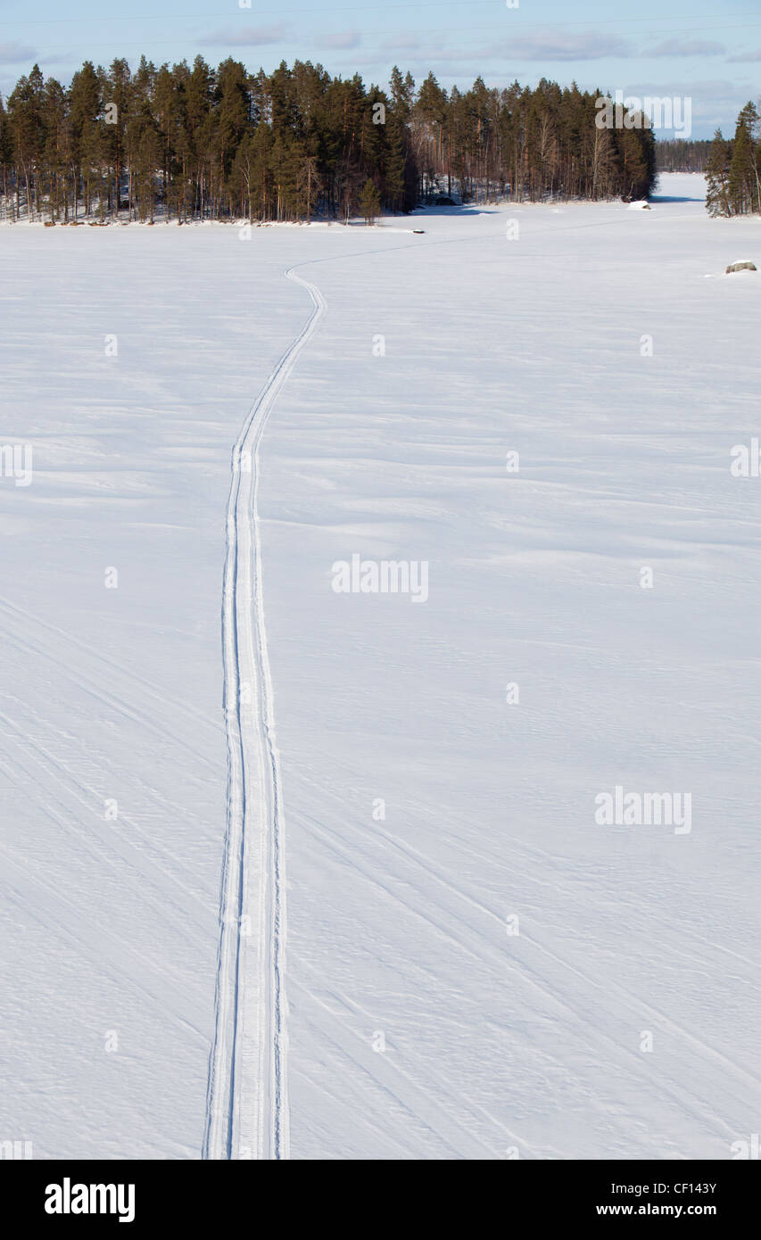 Isolated snowmobile trail on lake ice , Finland Stock Photo
