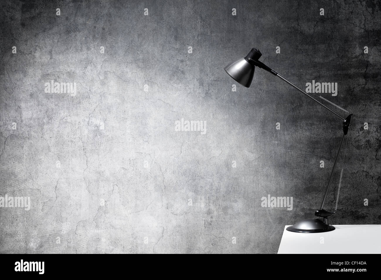 Desk lamp on the edge of a table. Stock Photo