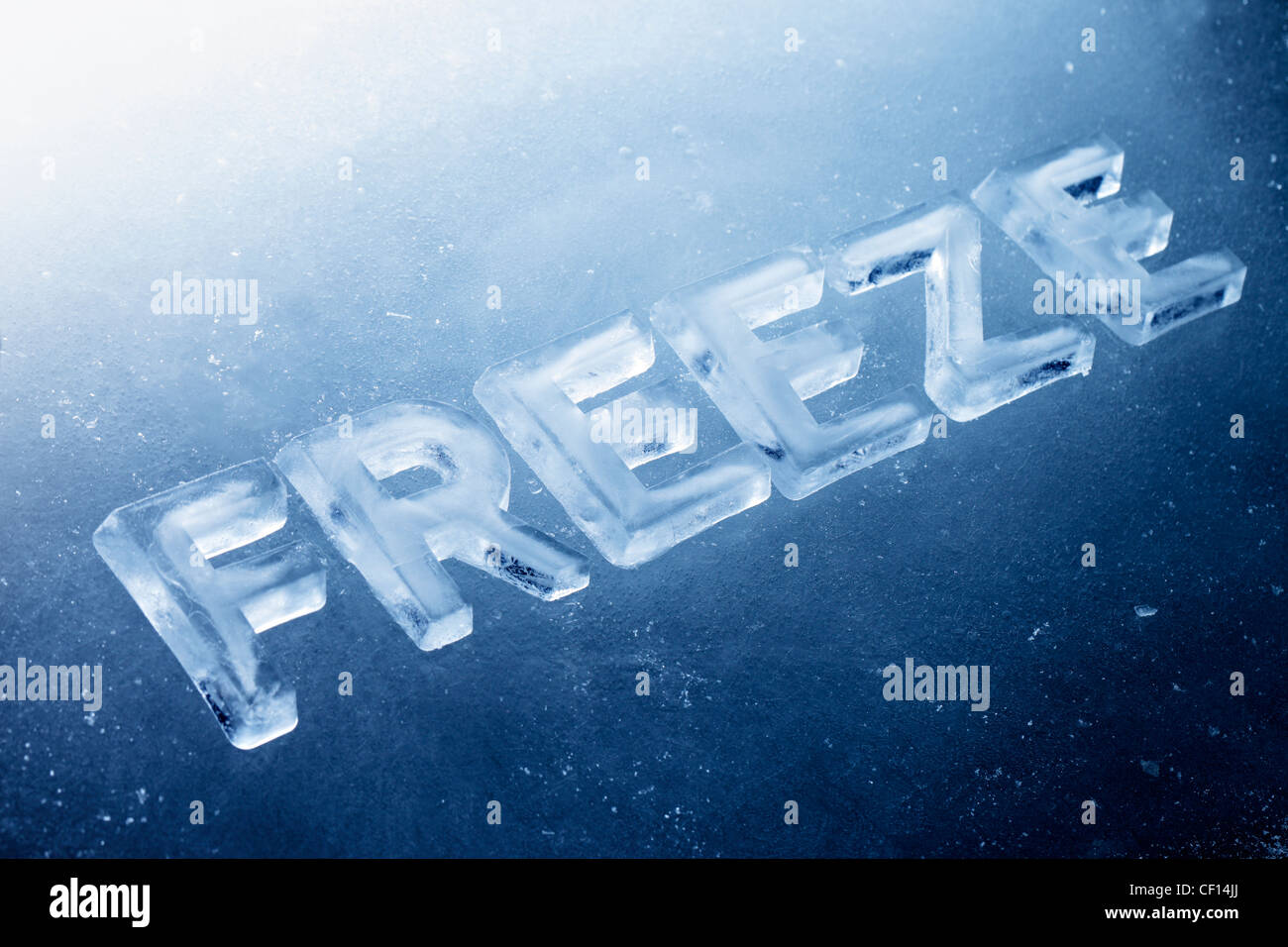 Word "Freeze" made of real ice letters on ice background. Stock Photo
