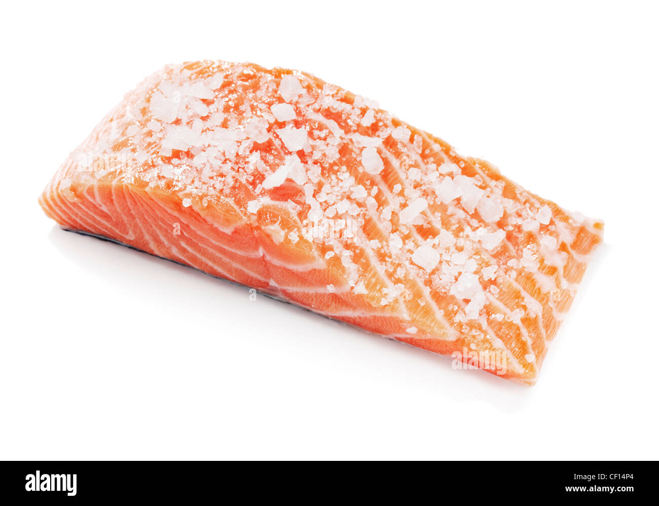 Salmon fish fillet salted with coarse salt. Isolated on white with
