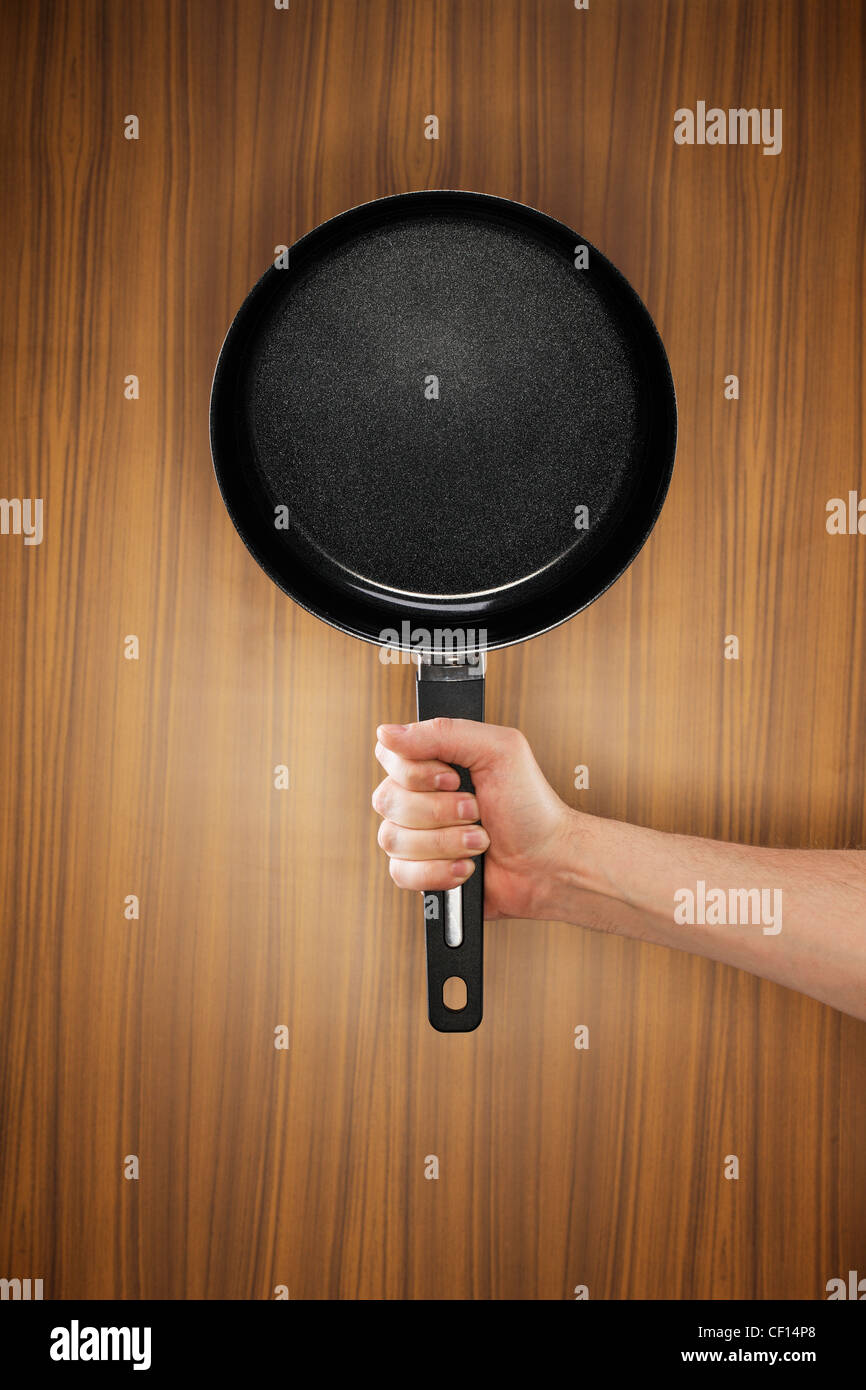Man holding a saucepan which has a ceramic non-stick coating Stock Photo