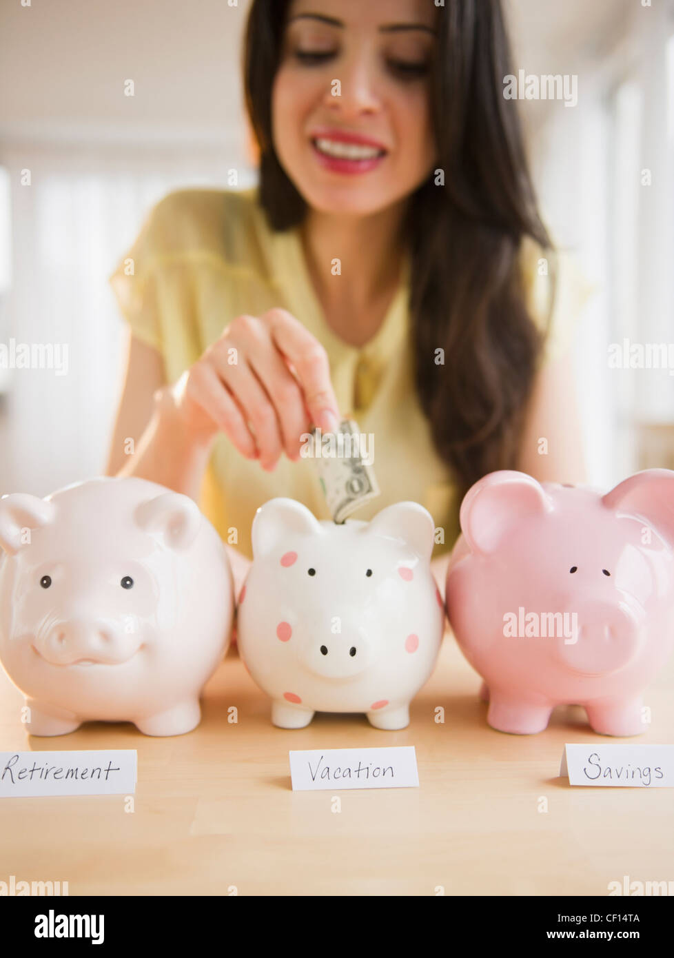 Woman looking on piggy bank hi-res stock photography and images - Alamy
