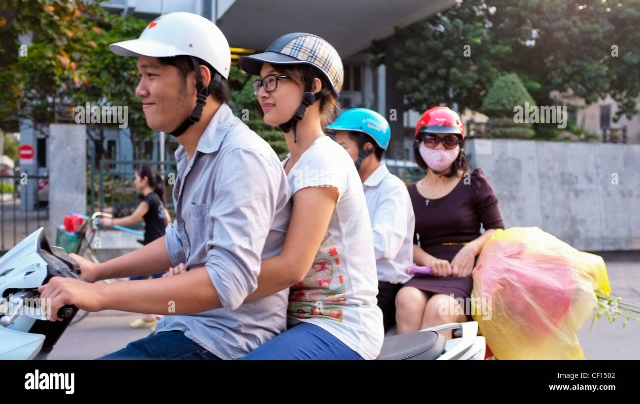 Couples riding scooter, Hanoi, Vietnam Stock Photo Alamy