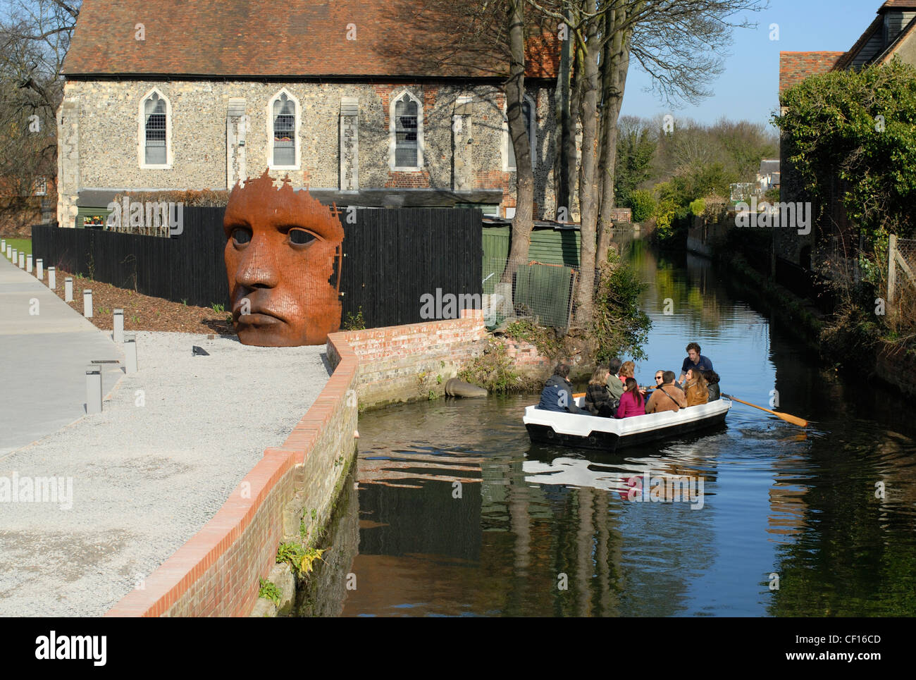 Tourists on rowing boat tour of Canterbury are show the Bulkhead sculpture at the marlowe Theatre Stock Photo