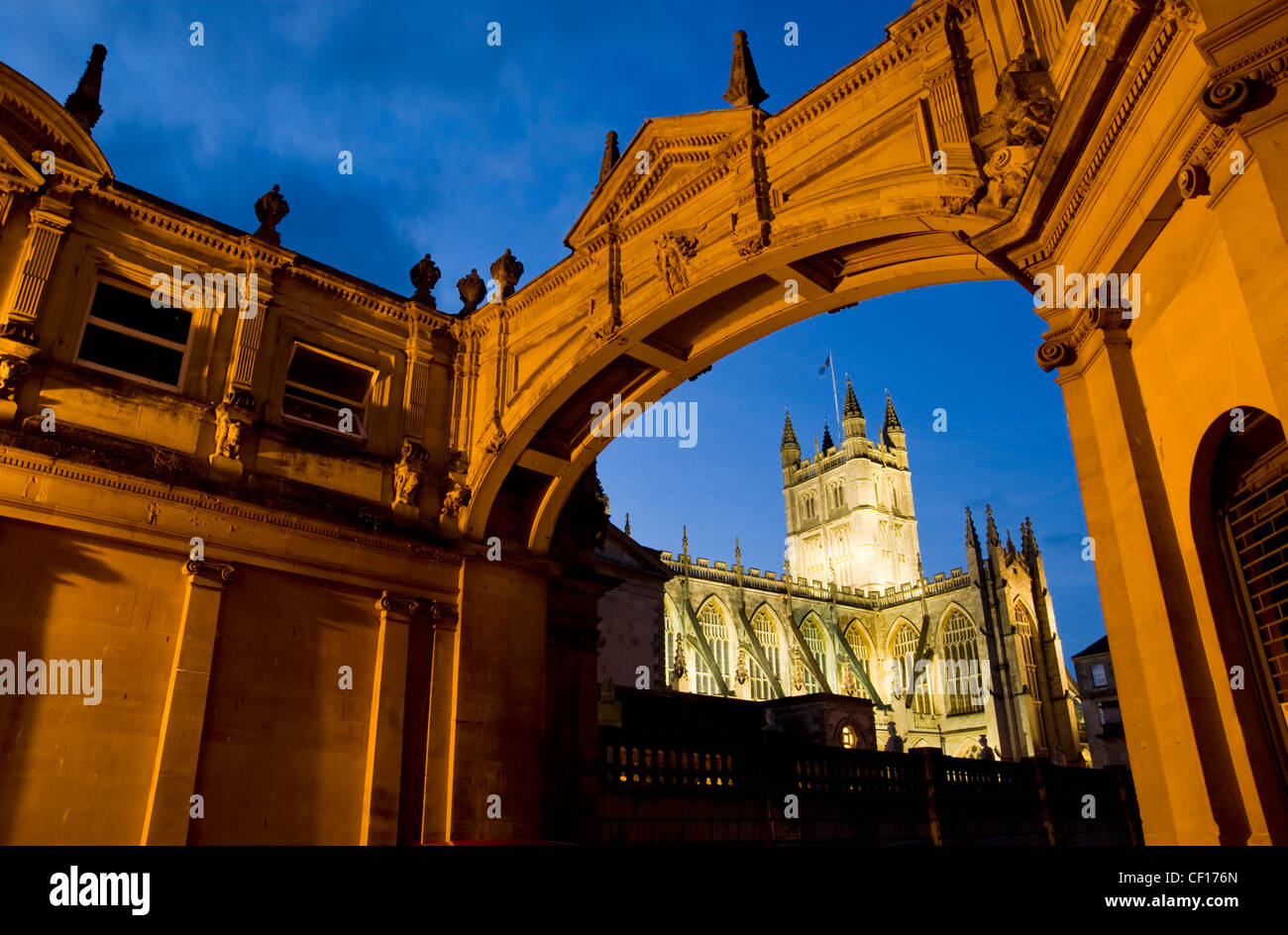A view of Bath Abbey at dusk framed by an archway Stock Photo
