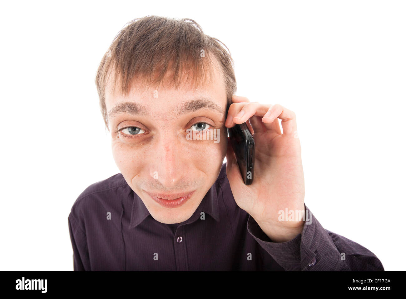 Happy weirdo nerd man on the phone, isolated on white background. Stock Photo