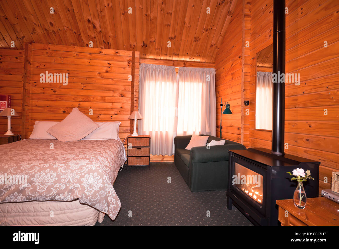 Lodge bedroom interior with fireplace. Fox Glacier Lodge, Fox Glacier