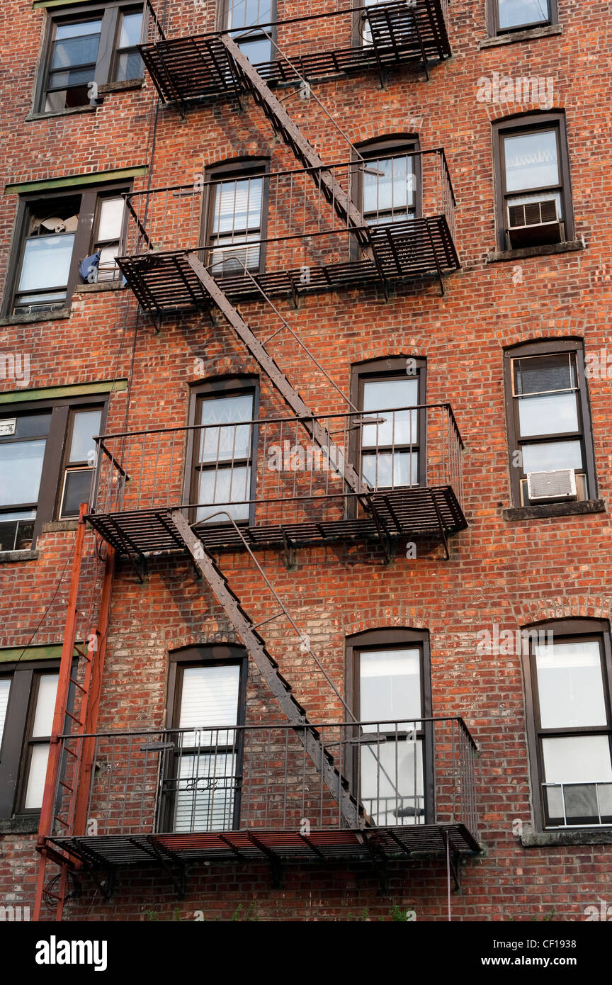 Fire escape ladders on side of brick apartment buildings, New York. Stock Photo