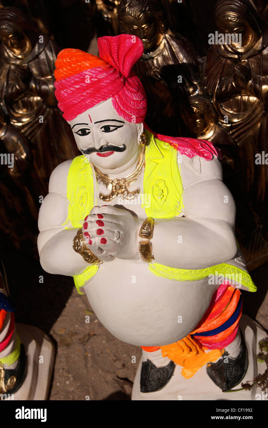A Namaste saying Aged Indian Paunch Man Sculpture Model Rajasthan handicrafts Stock Photo