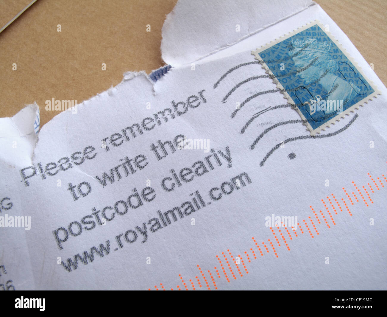 A close up of a  franked stamp on an envelop with an accompanying message to write the postcode clearly. Stock Photo