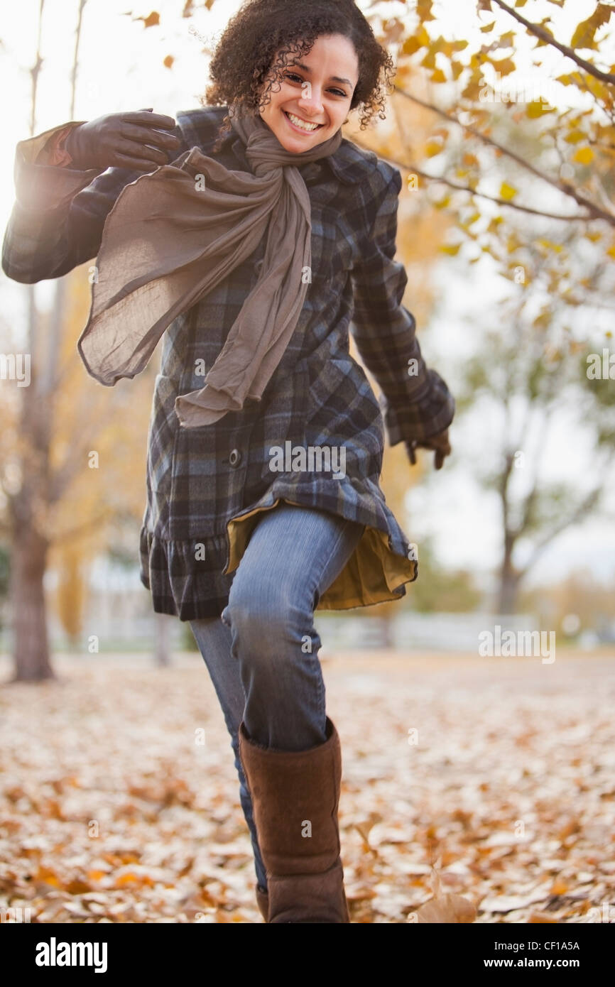 Caucasian woman running in autumn leaves Stock Photo - Alamy