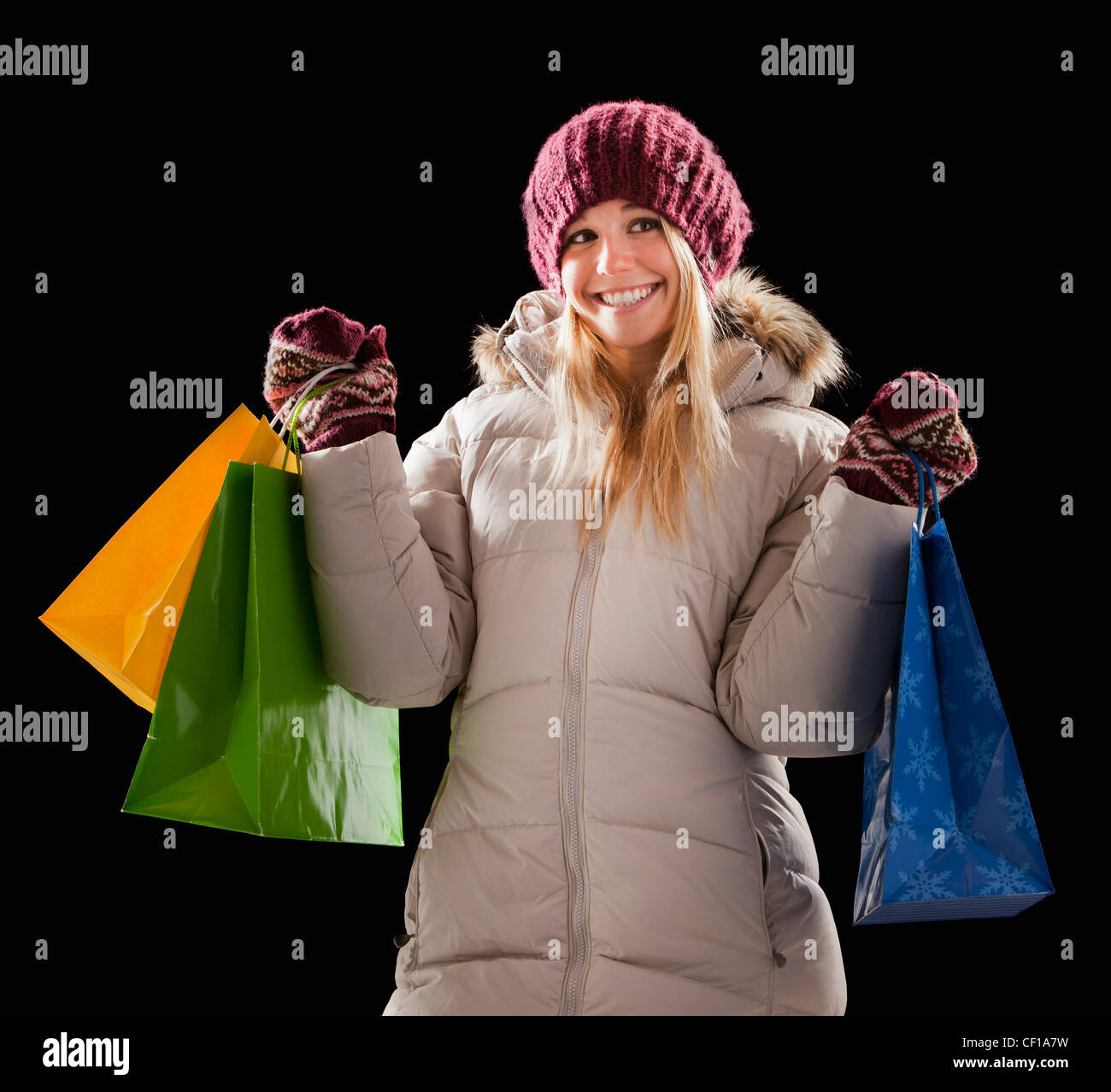 Caucasian woman in coat holding shopping bags Stock Photo - Alamy
