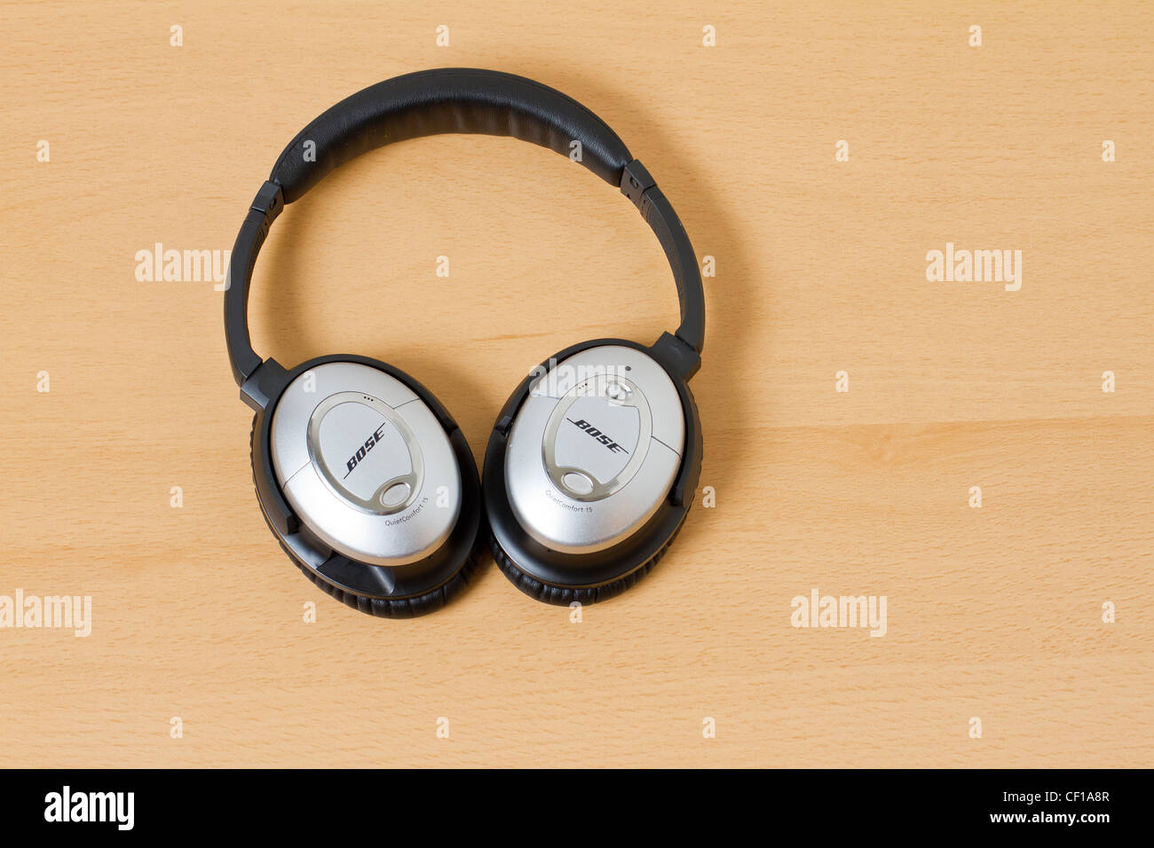 Noise canceling headphones Bose on a wooden background Stock Photo