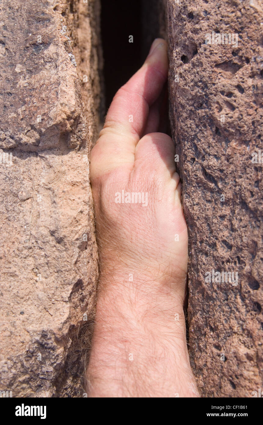 hand jam rock climbing hold in a crack Stock Photo