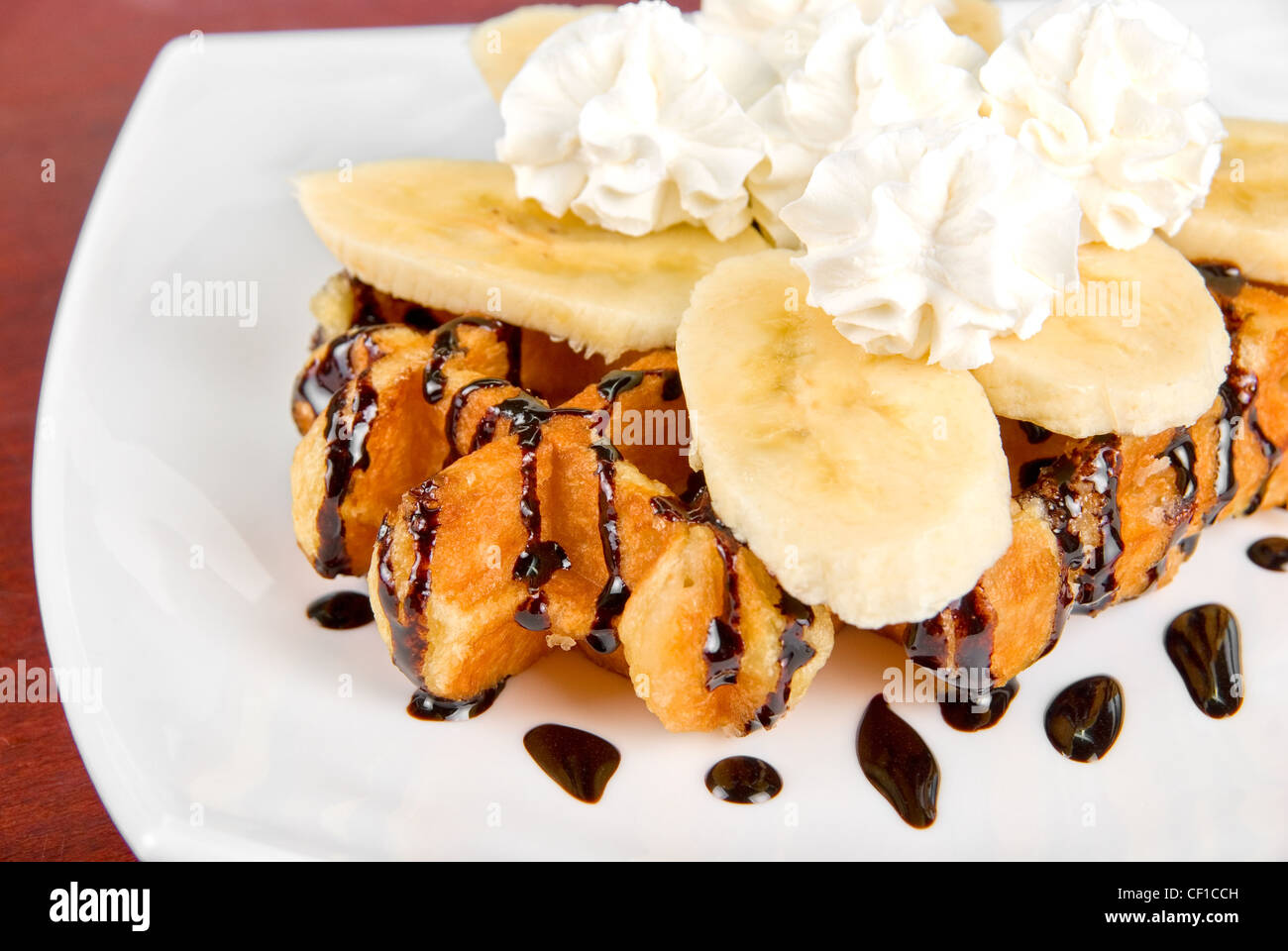 Tasty waffle with banana slices and ice cream Stock Photo - Alamy