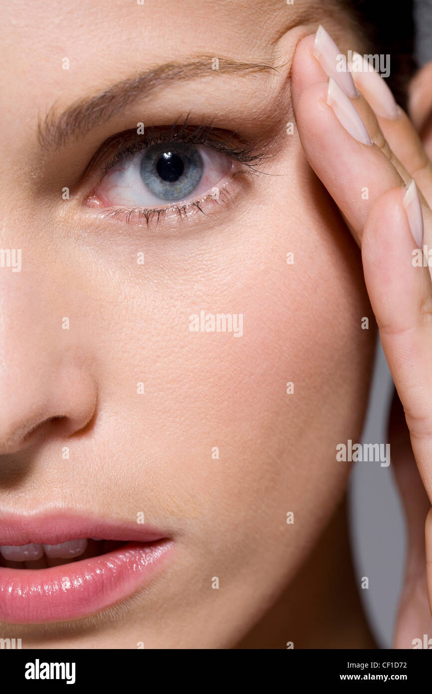 Woman fingers on temples hi-res stock photography and images - Alamy