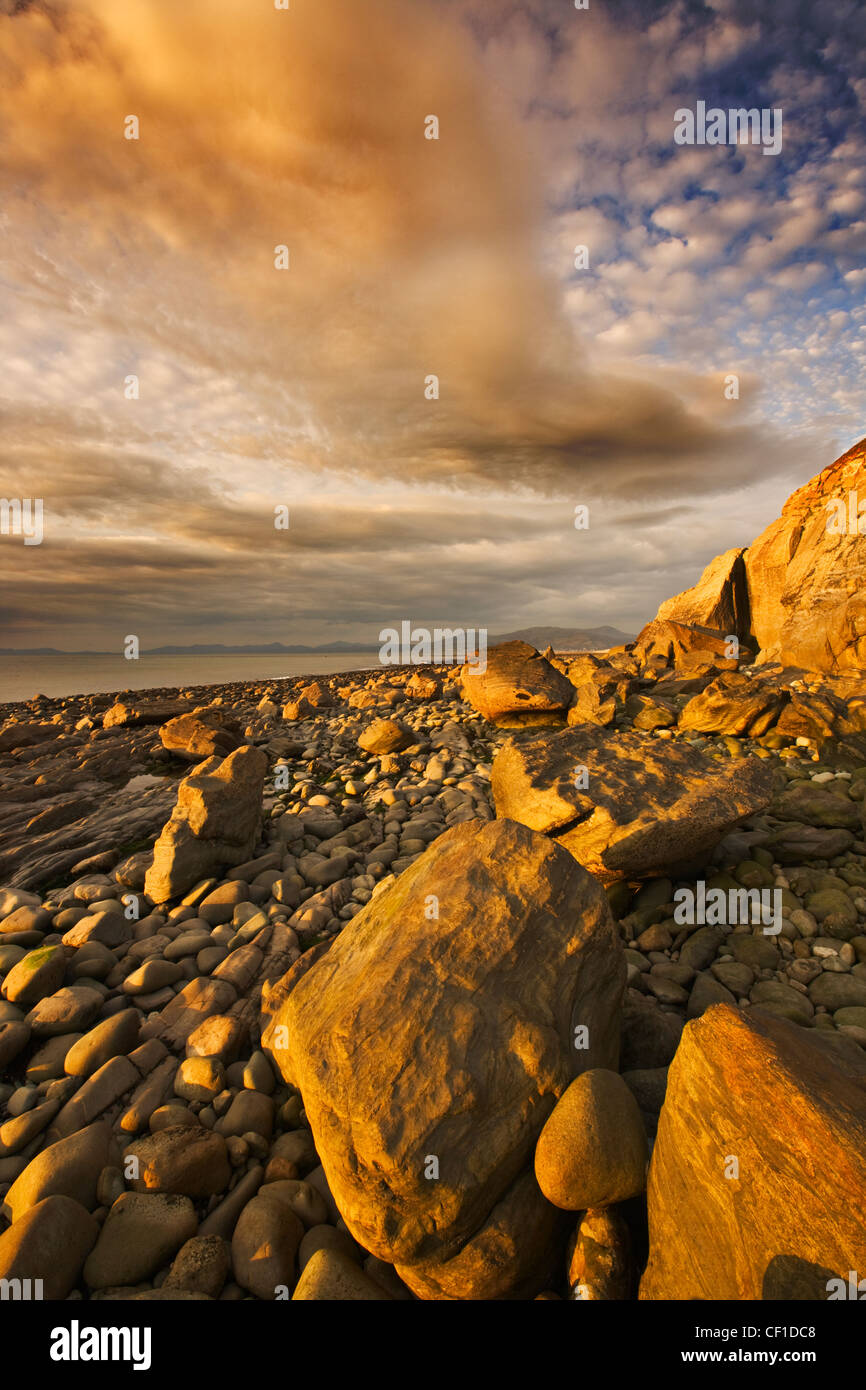 Storm light over a stoney beach near Llwyngwril in the Snowdonia ...