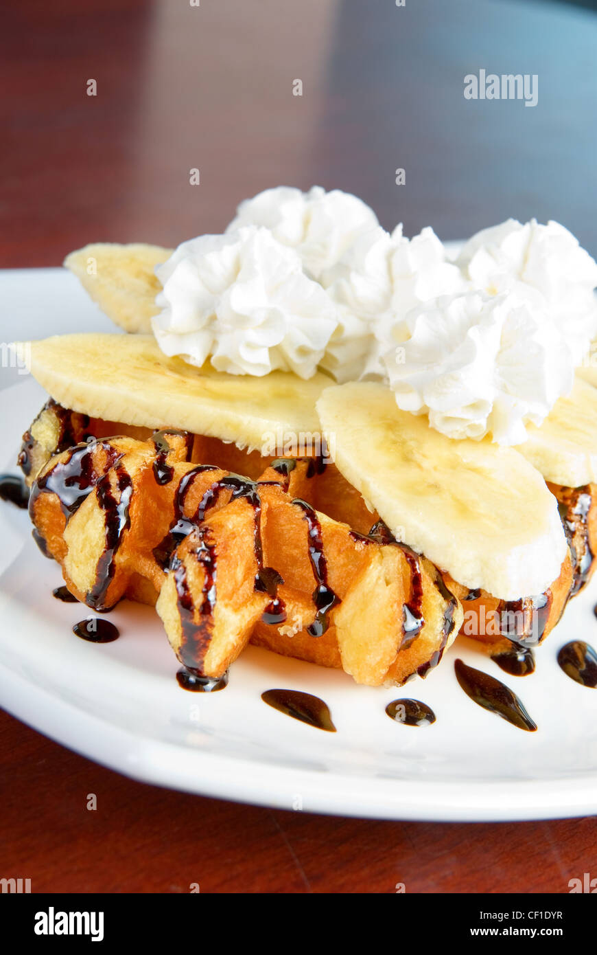 Tasty waffle with banana slices and ice cream Stock Photo - Alamy