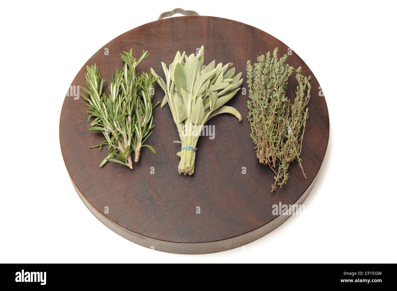 Fresh herbs on a kitchen chopping board Stock Photo