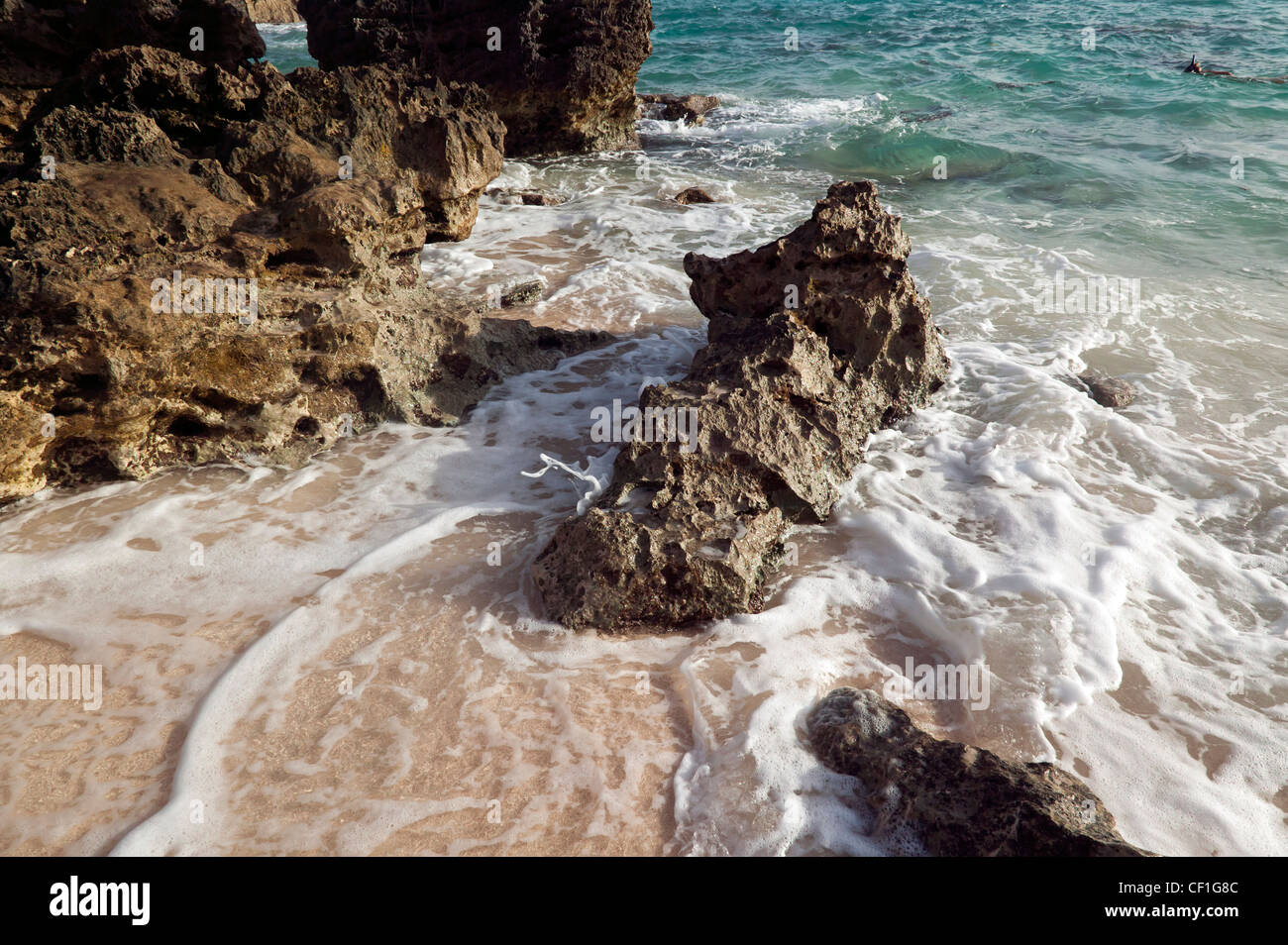 Evening tide coming in on the beach at Church Bay, Bermuda Stock Photo