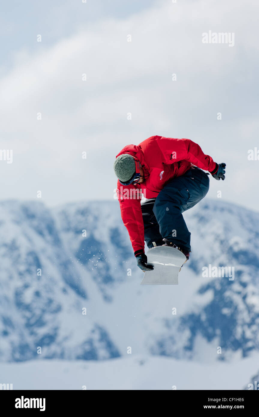 snowboarders getting big air during a competition at the summit of nevis range fort william scottish highlands scotland uk Stock Photo