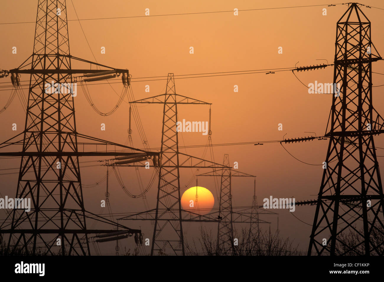 Electricity pylons silhouetted at sunset in Radley, Oxfordshire Stock Photo
