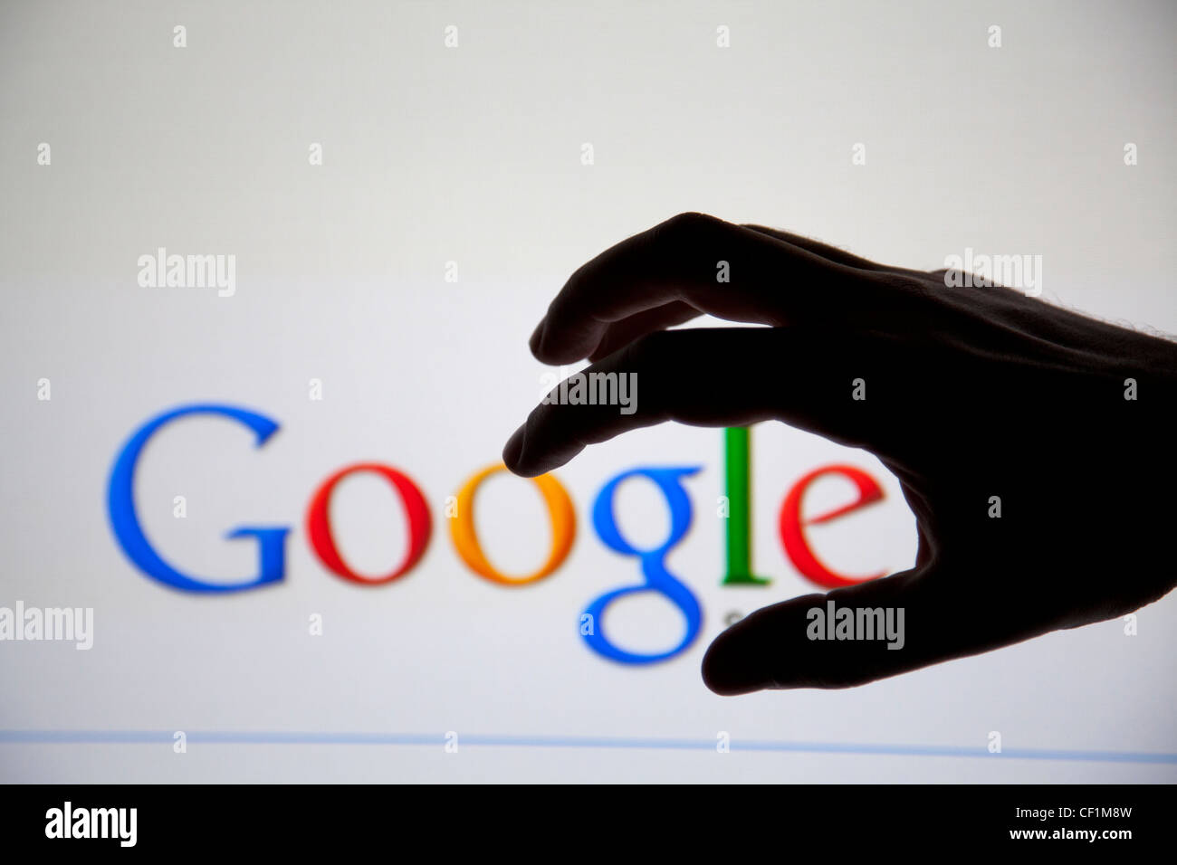 Hand Grabbing Google - focus on hand Stock Photo