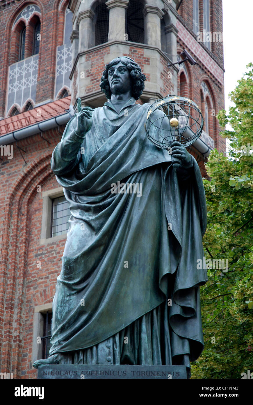 Monument to the astronomer Nicolaus Copernicus in front of the old city hall of the Polish city of Torun. Stock Photo