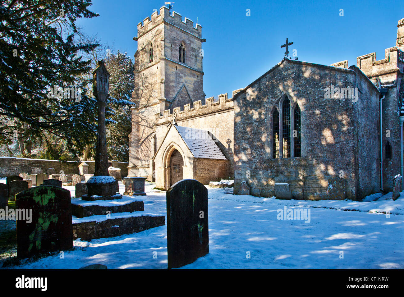 Snowy winter view of the Church of the Holy Rood or Cross in the Cotswold village of Ampney Crucis, Gloucestershire, England, UK Stock Photo