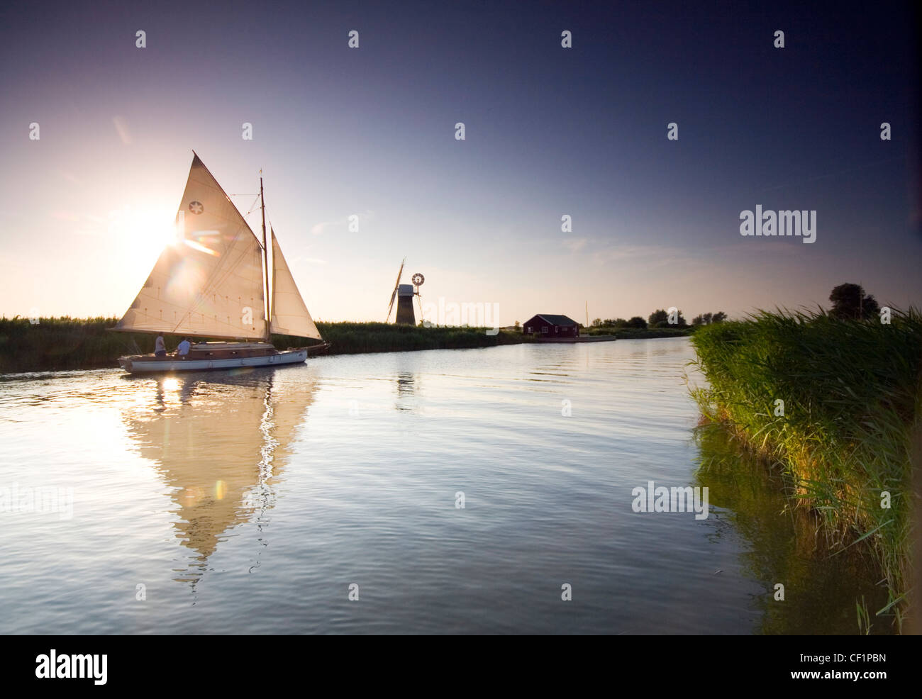 Sail boat on the River Thurne. The river lies in the Norfolk Broads. Stock Photo