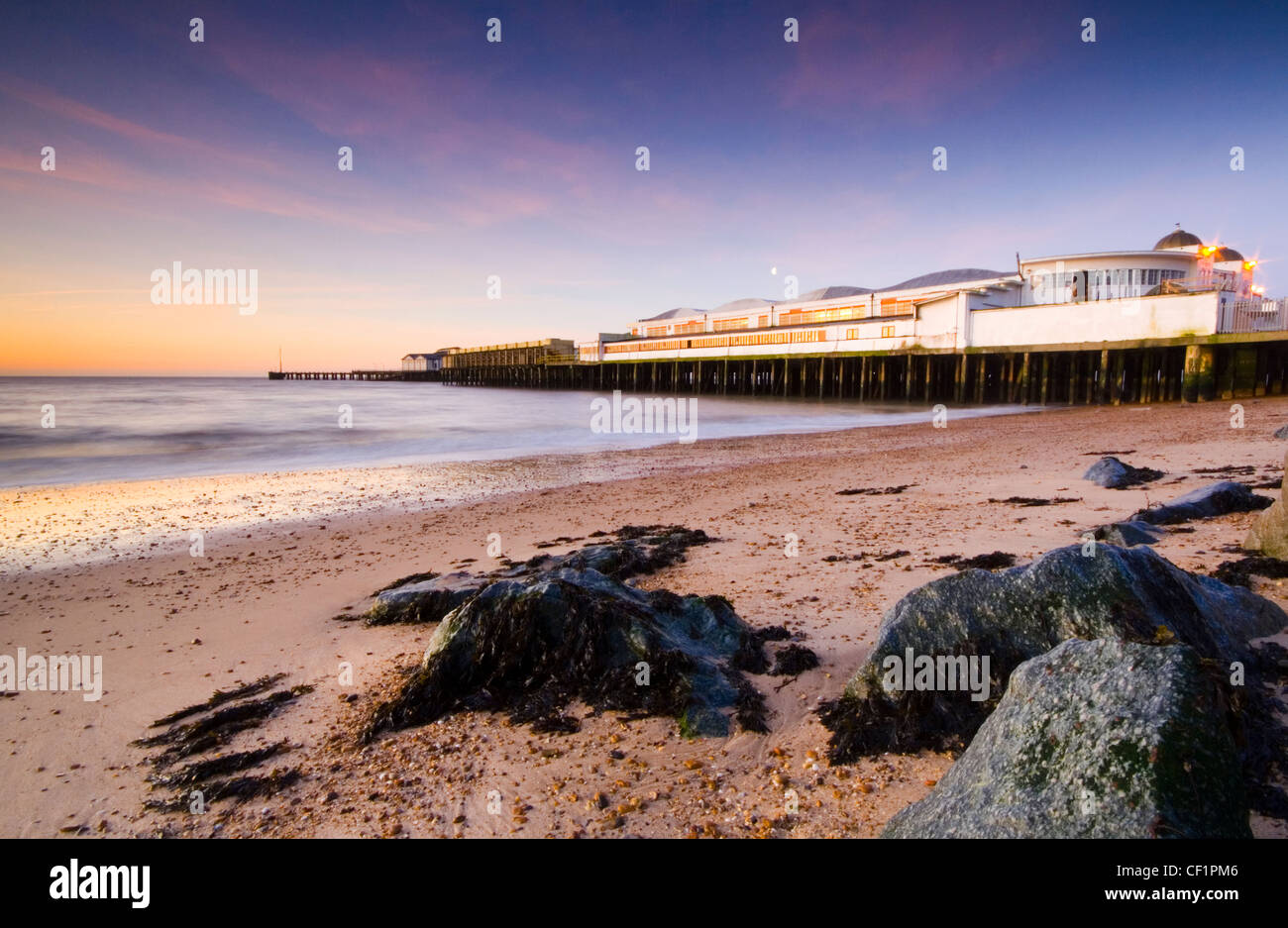Clacton pier at sunrise. Opened on 27 July 1871, the pier was just 160 yards in length and 4 yards wide. A scale of charges was Stock Photo