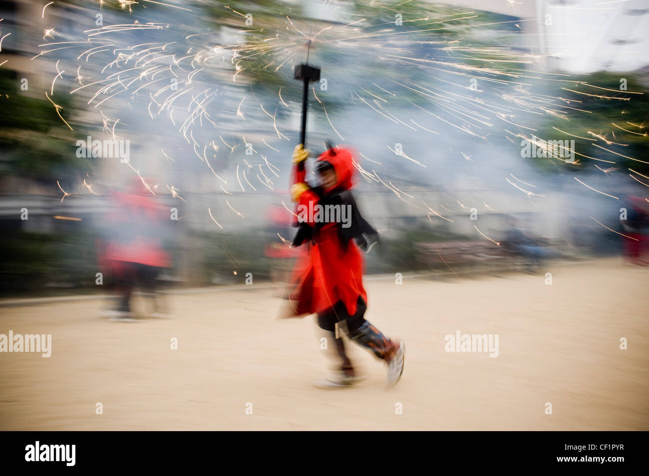 Fireworks and young devil on traditional Correfoc during a typical ...