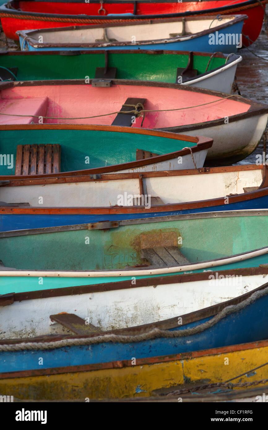 A row of colourful rowing boats near the river at Leigh-on-Sea. Stock Photo