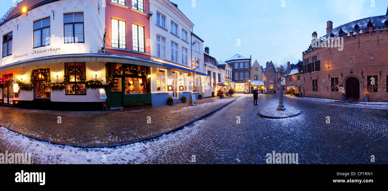 A panoramic view of a traditional cobbled snow covered square at Huidenvetters Plein Stock Photo