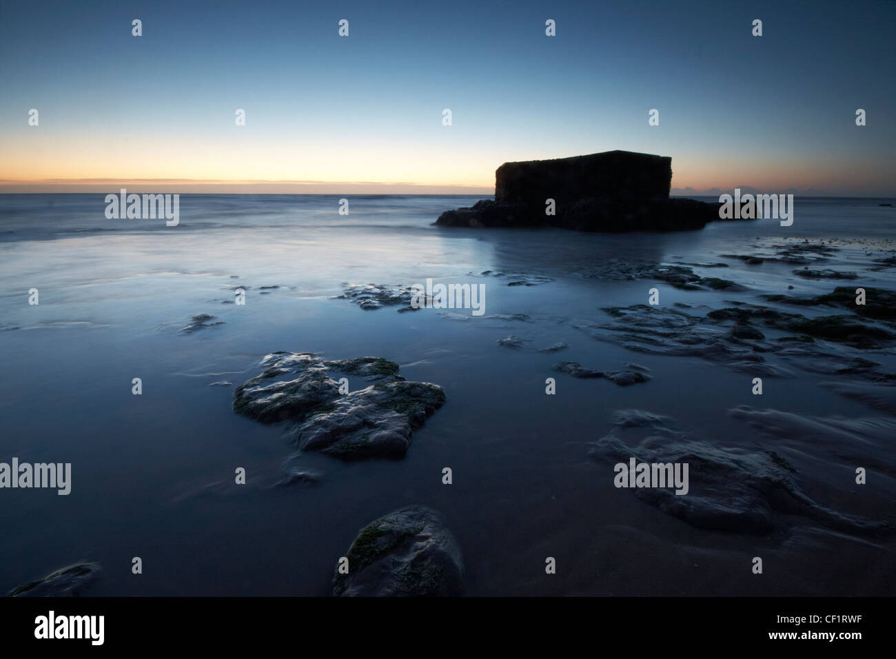 A pillbox on the beach at the Naze in early dawn light. Stock Photo