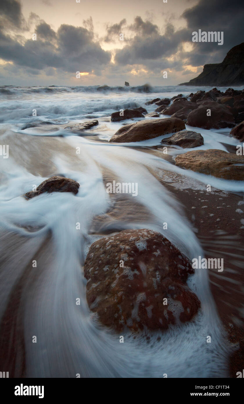 Waves rushing onto the beach at Saltwick Bay. Stock Photo