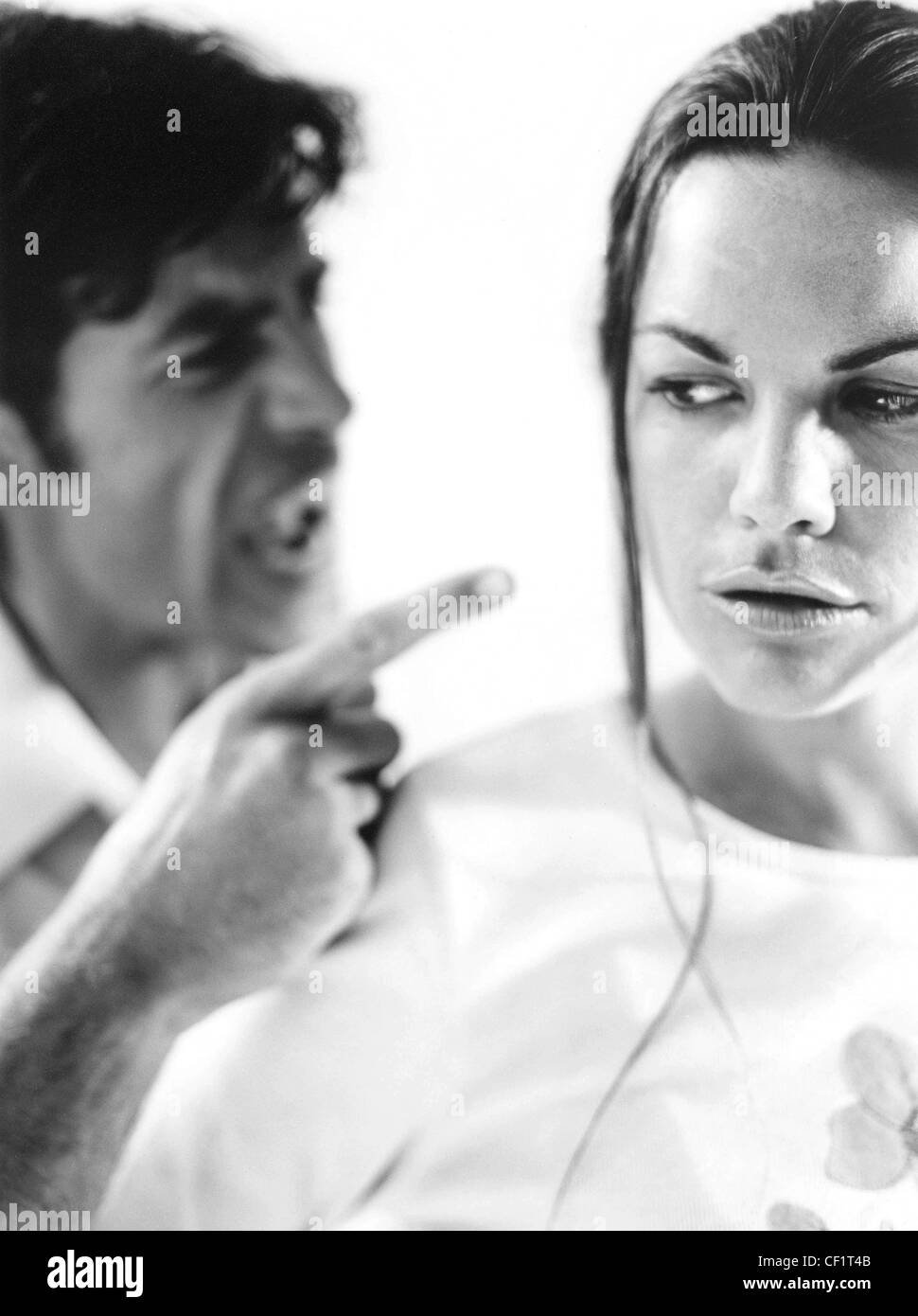 Couple arguing male shouting at female aggressive expression female with back to him looking behind her Stock Photo