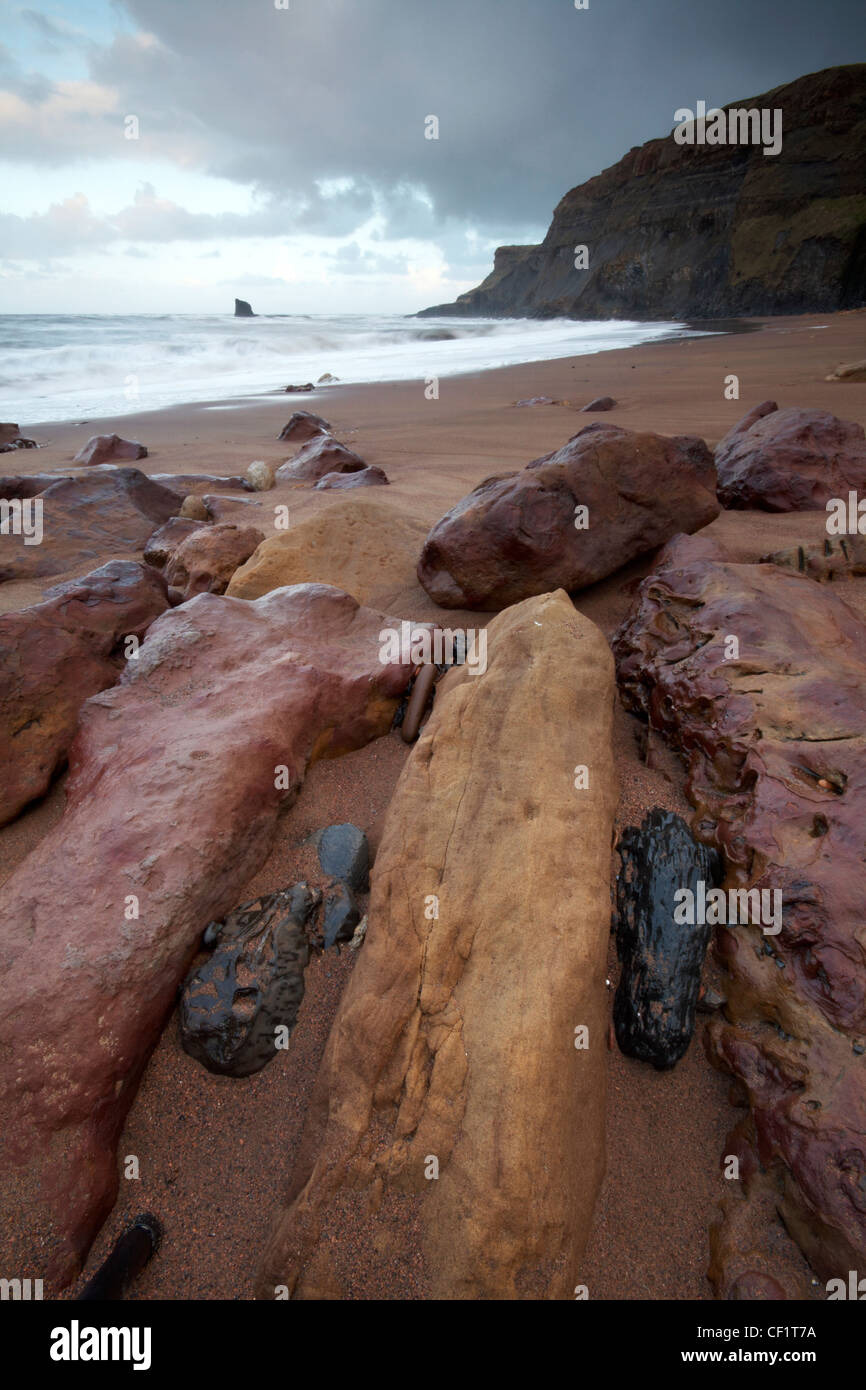 The tide rolling onto the beach at Saltwick Bay. Stock Photo