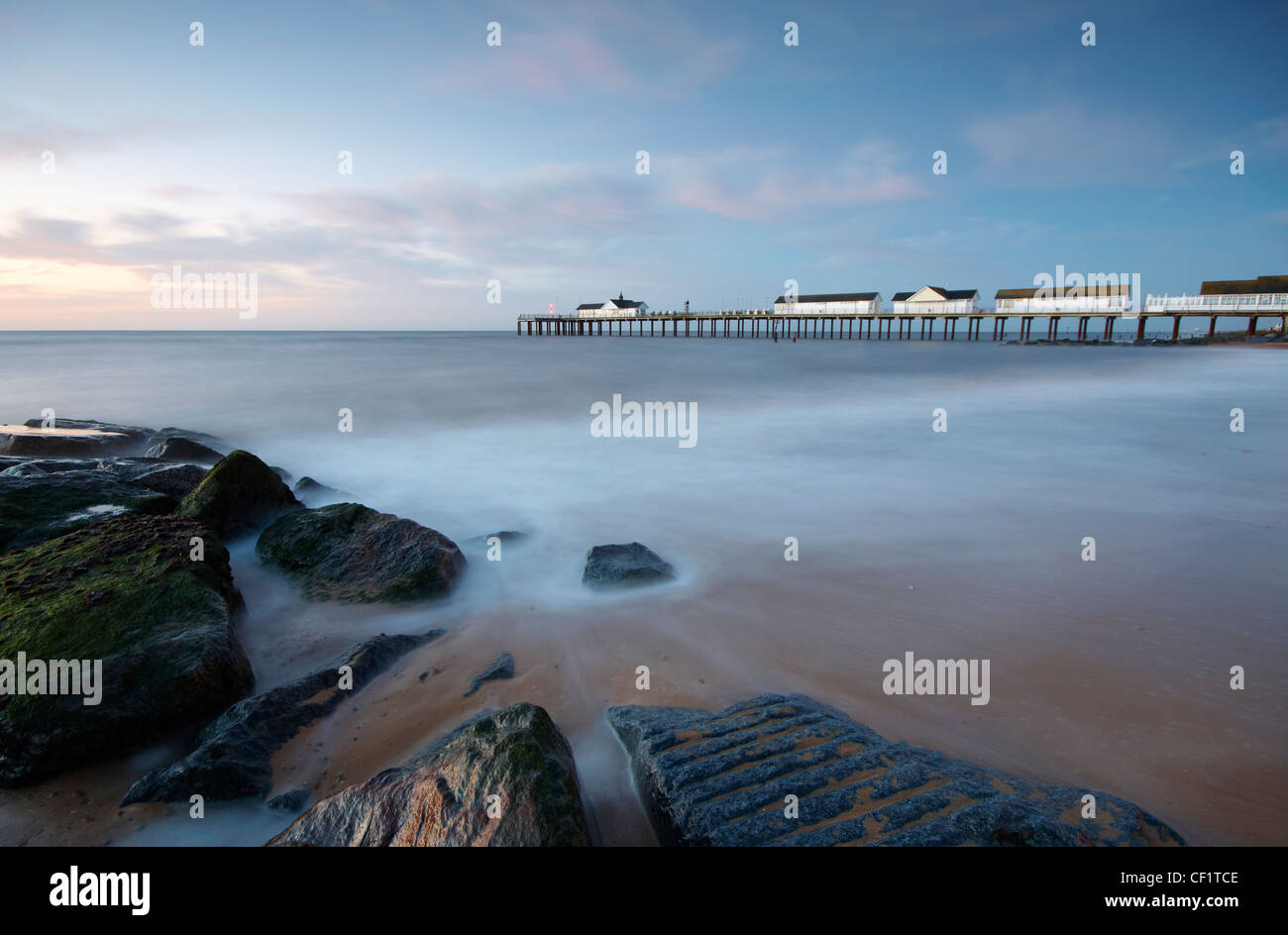 The tide ebbing from the beach by Southwold pier before sunrise Stock